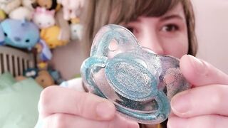 Violet playing with her blue pacifier