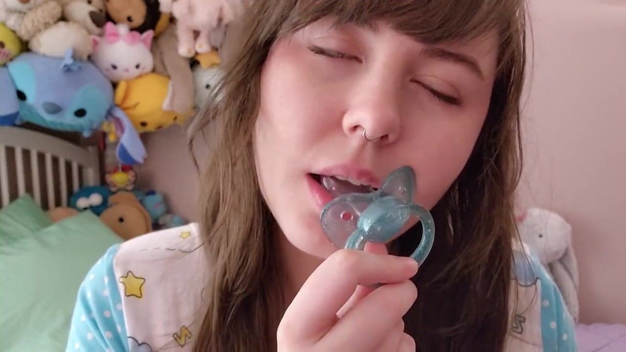 Violet playing with her blue pacifier