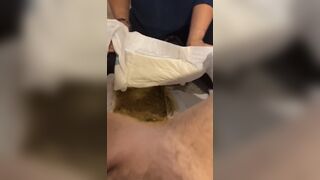 mom changes dirty diaper