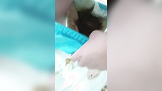 Girl shows mess in cloth diaper
