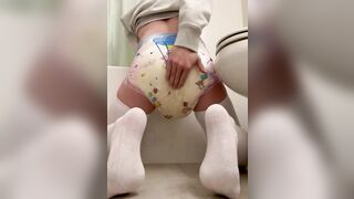 Messing diaper near toilet