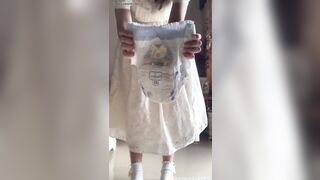 ABDL Asian Girl changes her diaper while standing up