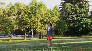 Cute girl needs to poop while on her phone in the park