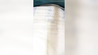 Girl grunts and pushes mess into diaper