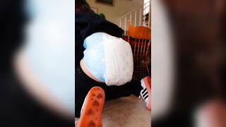 Girl messing diaper in front of desk