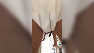 Girl pooping her diaper in the bathroom