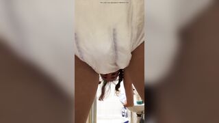 Girl pooping her diaper in the bathroom